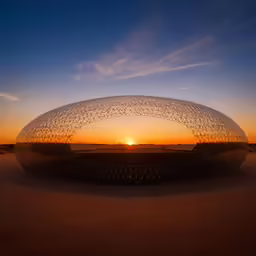 large sculpture sitting in the middle of a desert