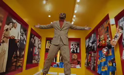 a fake man with his arms spread over a display