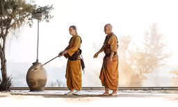 the three monks with a cane and stone vessel behind them