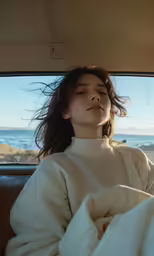 a young woman is sitting in a car on a sunny day