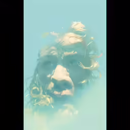 a man is submerged in water with his head tilted to the side