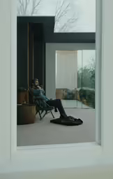 there is a man sitting in the chair talking on the phone