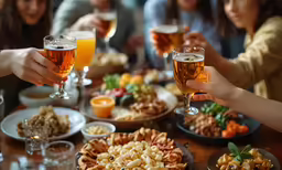 there are many people that are drinking wine and pizza