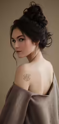 a young woman with her tattoo in gold ink