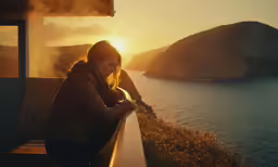 a woman looking down at her cell phone