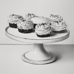 a dessert plate with many cupcakes in black and white