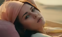 woman laying down and gazing into the distance