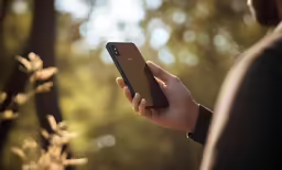 a person holding a cellphone in their hand