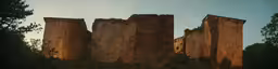 the sun is peeking out of between these rocks