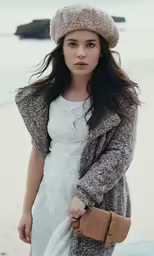 a girl in a white dress is posing for a photo