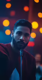 man with microphone in bright room during party