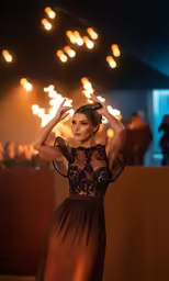 the woman in the long dress is wearing a very unusual hat