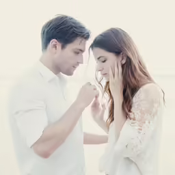 a man and woman are talking on the beach