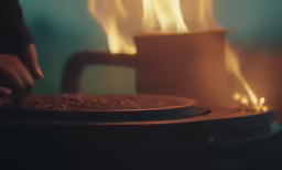 a close up of a person touching something on a grill