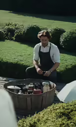 a person sits in front of an outdoor grill