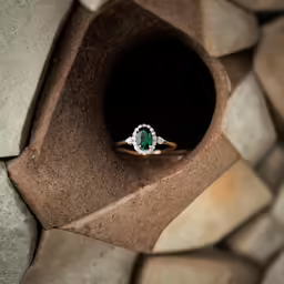a close up image of a ring in a hole with rocks around it