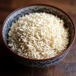 rice sprinkled in a bowl on top of a table