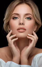 a woman with short hair and a white dress poses in front of a black background