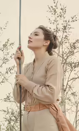 an older lady holding a long pole standing