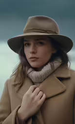 the girl in a coat is wearing a hat