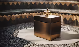 a golden vase sitting on top of a table next to a staircase