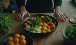 a person is putting ingredients into a black bowl