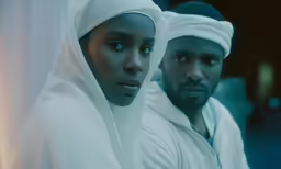 a man and woman dressed in white