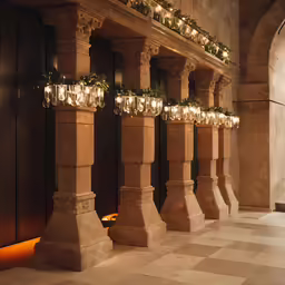 pillars lit with lights next to an entryway