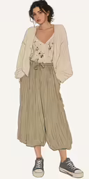 a woman wearing a top and plea pants with black lace