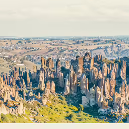 an aerial view of rock formations and green vegetation