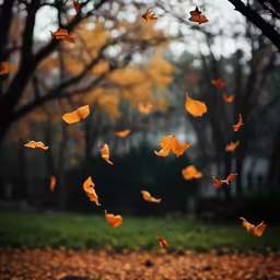 a flock of orange butterflies in the air over leaves