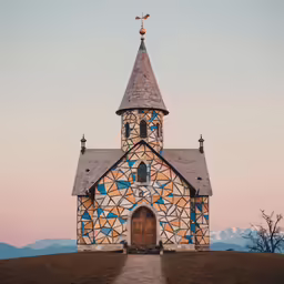 an unusual church with blue windows sits on a hilltop