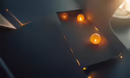 candles that are lit next to a plate