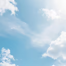 there is a bright blue sky with clouds