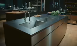 a metal sink and counter in a room