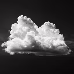 a large cloud is above the black and white clouds