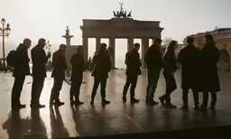 there are people standing in front of a very tall building