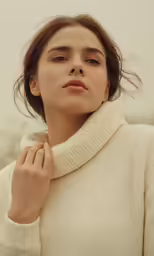 a woman with the hood pulled up to her chest