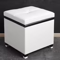 an upholstered white stool sitting on top of a floor