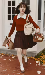a young woman with two purses walks down a path