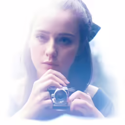 a girl holding a camera in front of her face