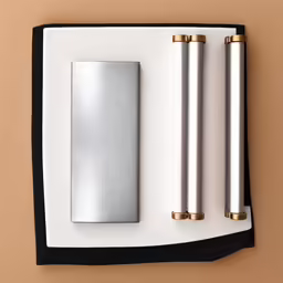 3 different sized batteries on paper with gold trimming