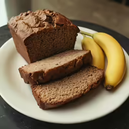 a white plate with sliced bread and a banana on top of it