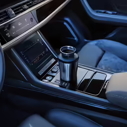 the car has a blue interior and a dashboard with an electronic device