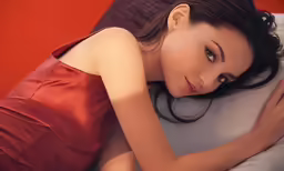 a woman in a red dress sitting down