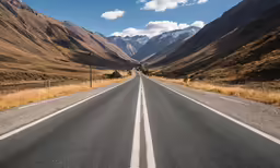 an empty highway is leading into a valley