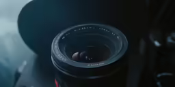 a wide angle camera lens sitting next to a hat