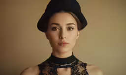a woman wearing a top hat with a black lace neck neck