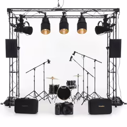 some lights on and a black drum, a set of speakers, a drum throne and other accessories