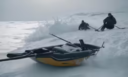 two skiers travel through the snow with their ski equipment